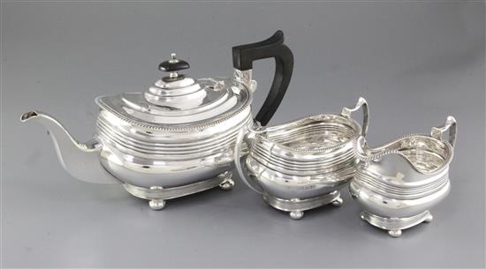 A 1940s silver three piece tea set, by William Bush & Sons, teapot height 156mm, gross weight 41.2oz/1283grms